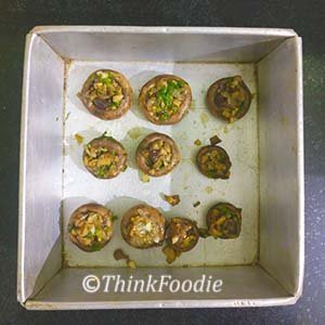 Place stuffed mushrooms in a baking tray.